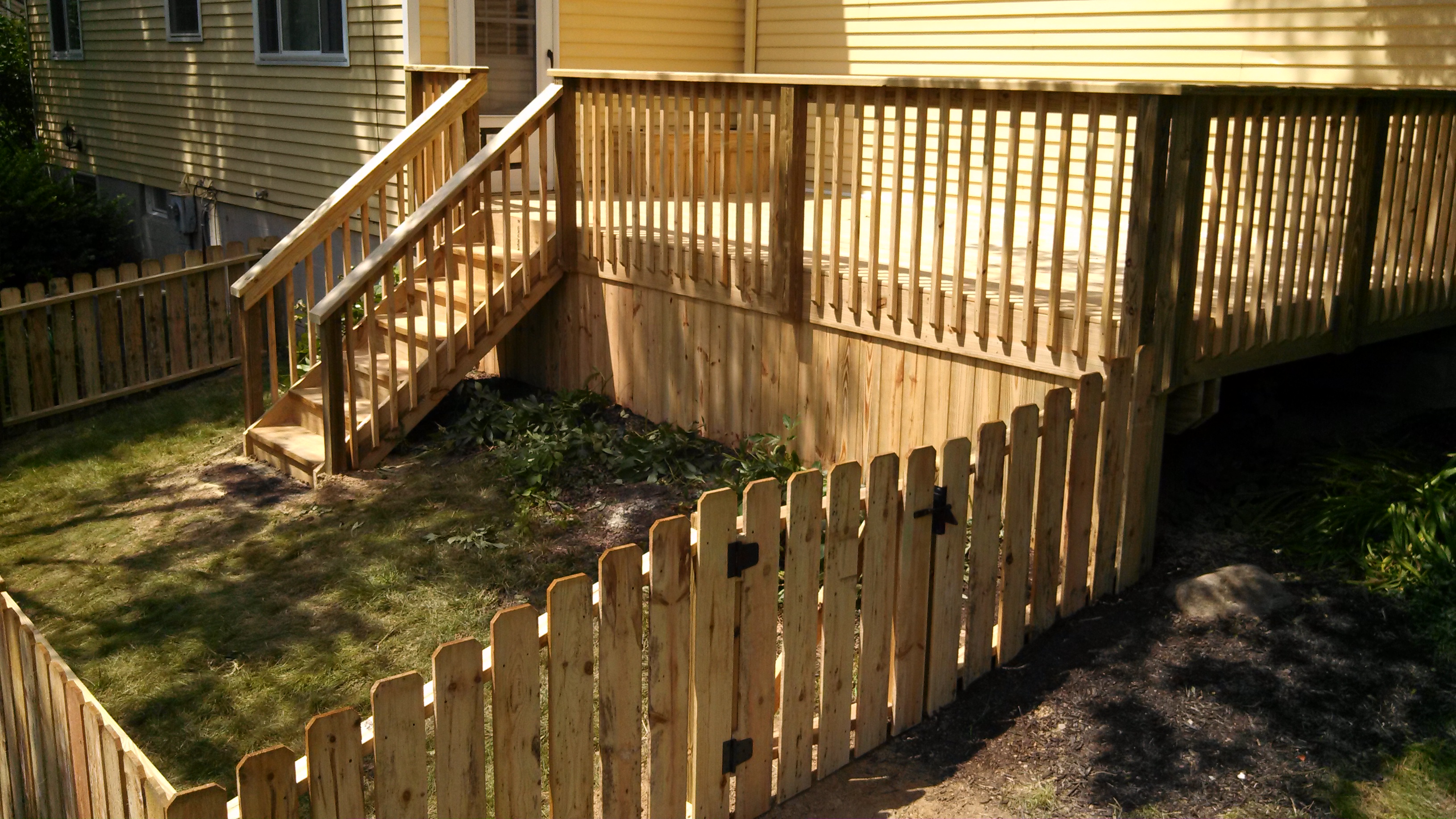 Treated wood deck and fence installed by Buckstone Builders in Stow - Summit County, Northeast Ohio